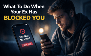 Man staring at phone after ex blocks him, illustrating breakup advice on what to do when your ex has blocked you.