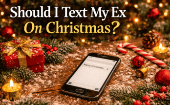 Phone on a table with Christmas decorations and a drafted ‘Merry Christmas’ text message, representing the question of whether to text an ex on Christmas.