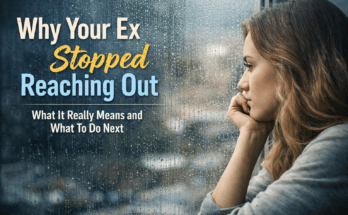 A thoughtful young woman looking out a rainy window after a breakup.